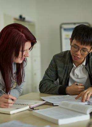 A male and a female student working together in an Abertay classroom.