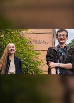 Image shows Jamie Williams and Jordan Han outside the Abertay library 