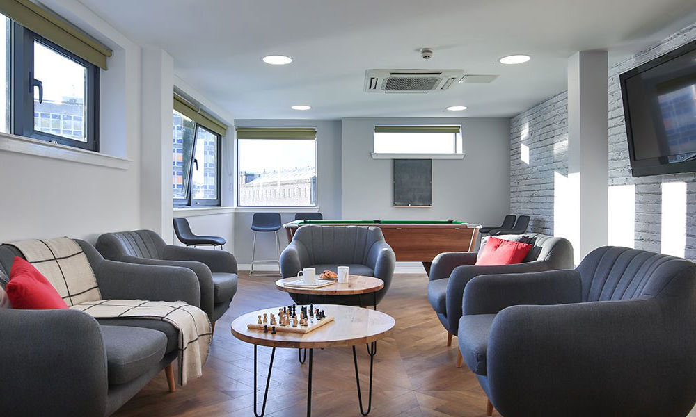 Large lounge with sofas and wall mounted TV