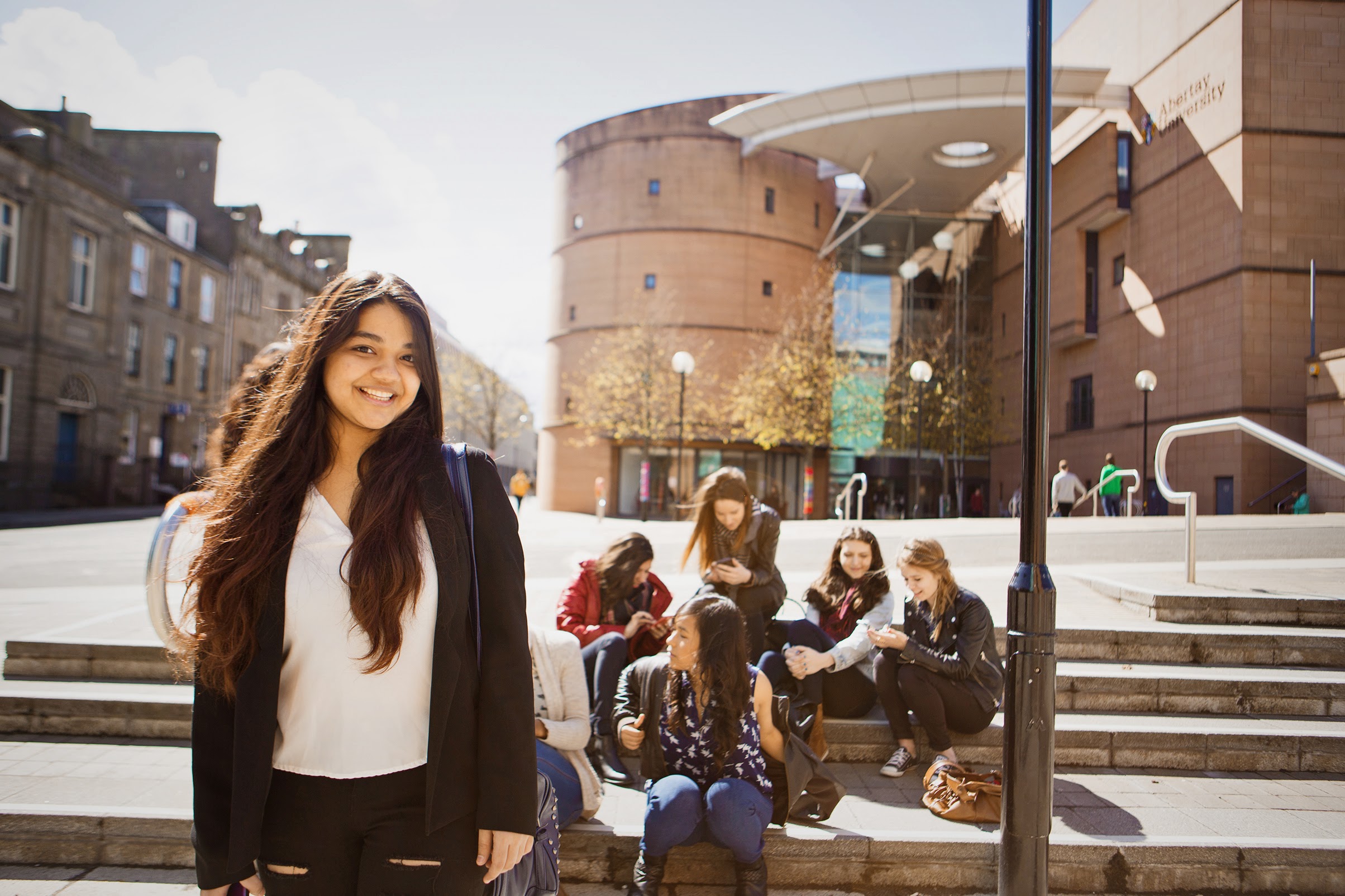 Group of people sitting on steps outside The Bernard King Library