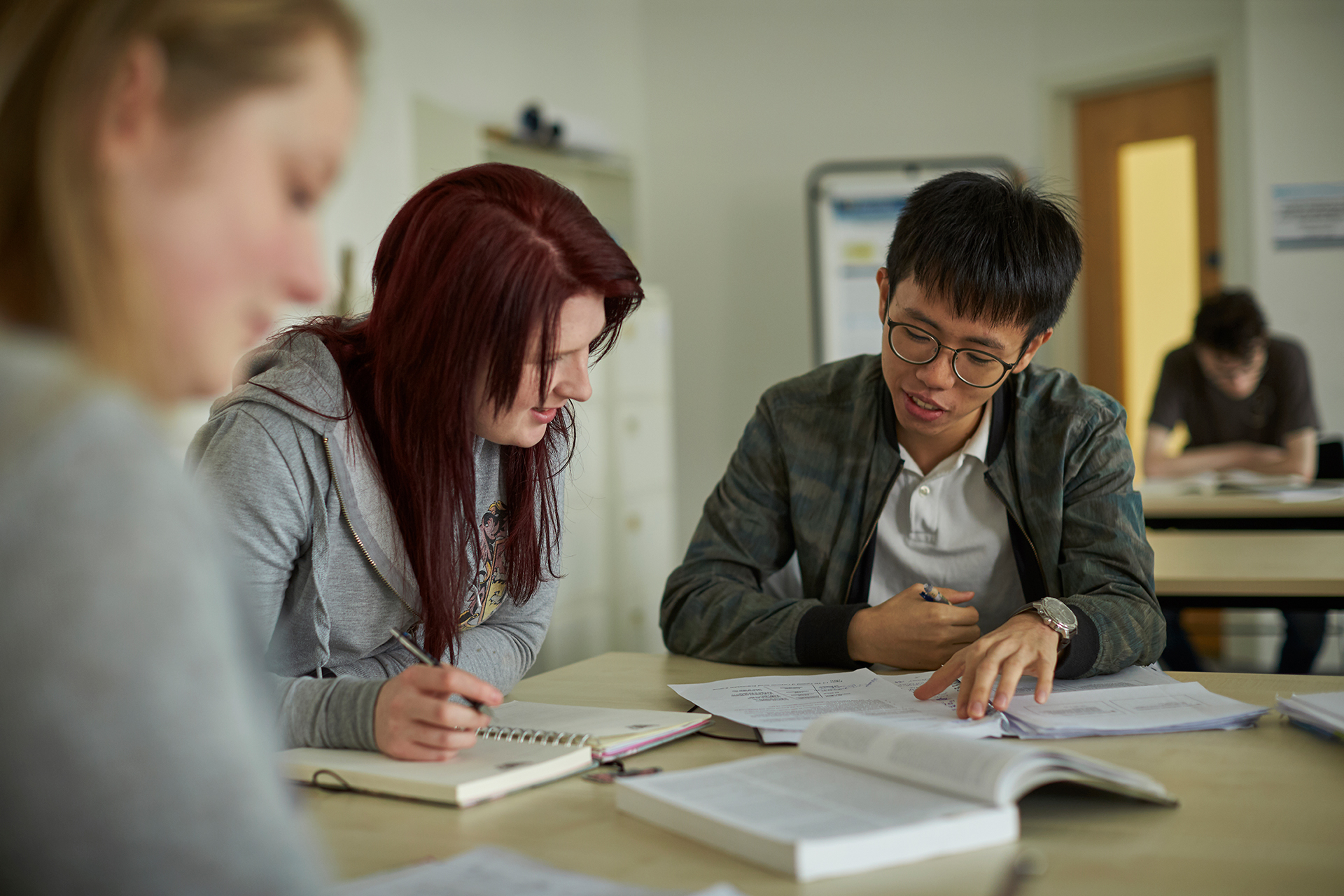 A male and female student working together in an Abertay classroom.