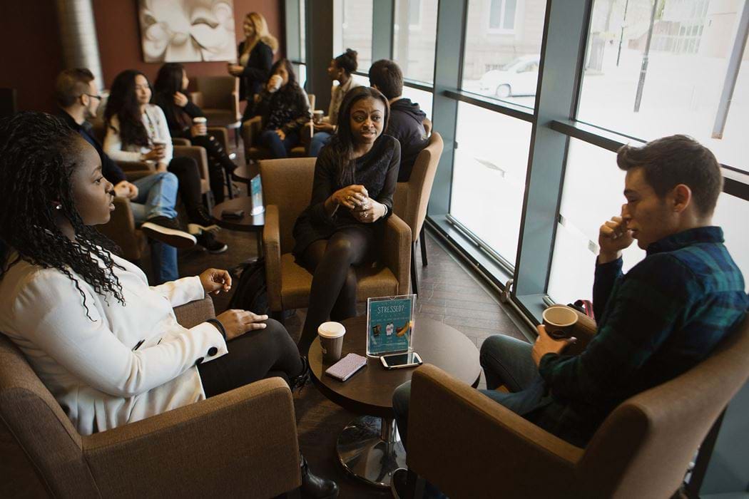 Group of people sitting chatting in a coffee shop