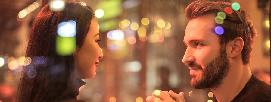 The image shows a male and a female staring lovingly into each others eyes.