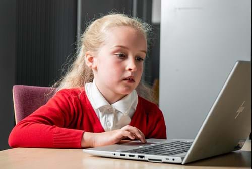 Girl sitting at laptop computer