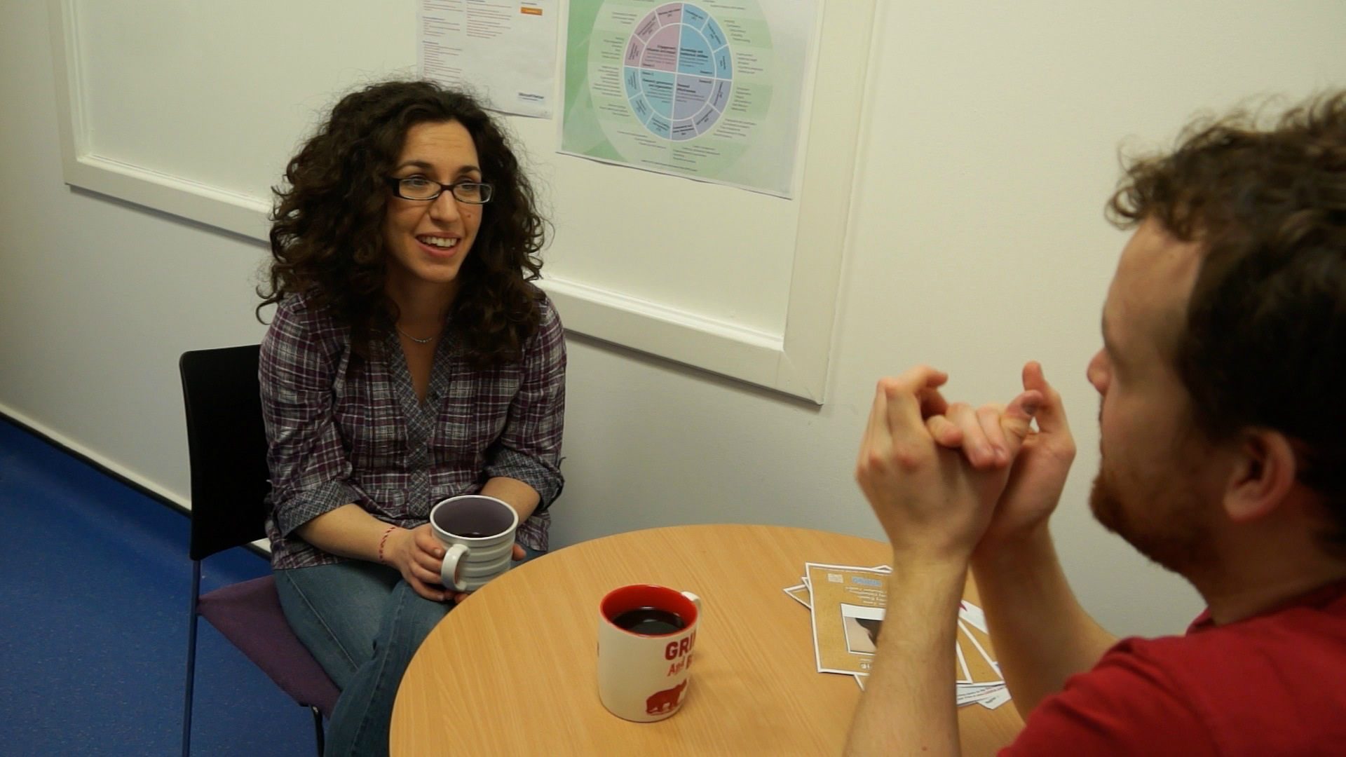 Male and female chatting and drinking coffee