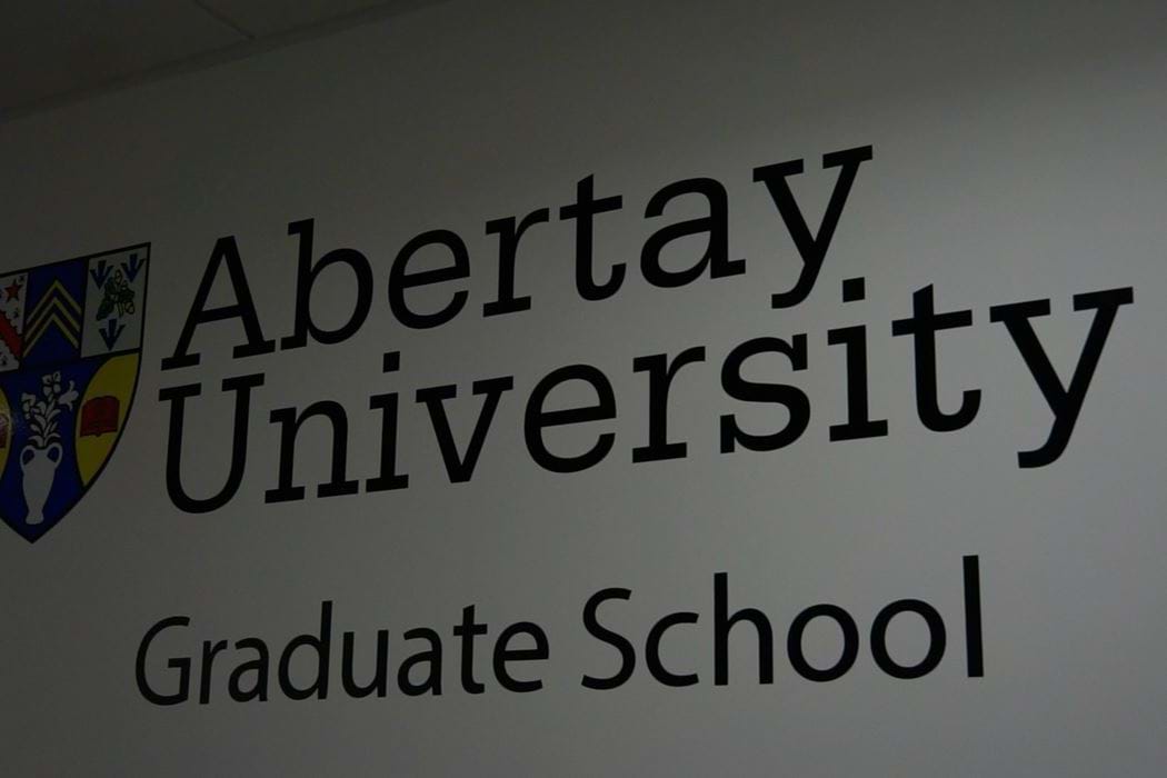 The words "Abertay University Graduate School" printed on a wall
