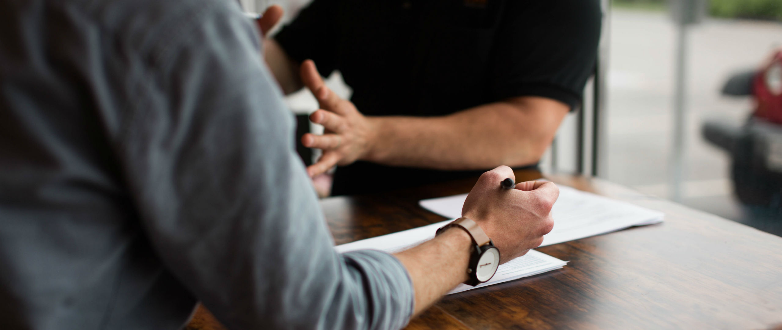 A hand writing on a piece of paper