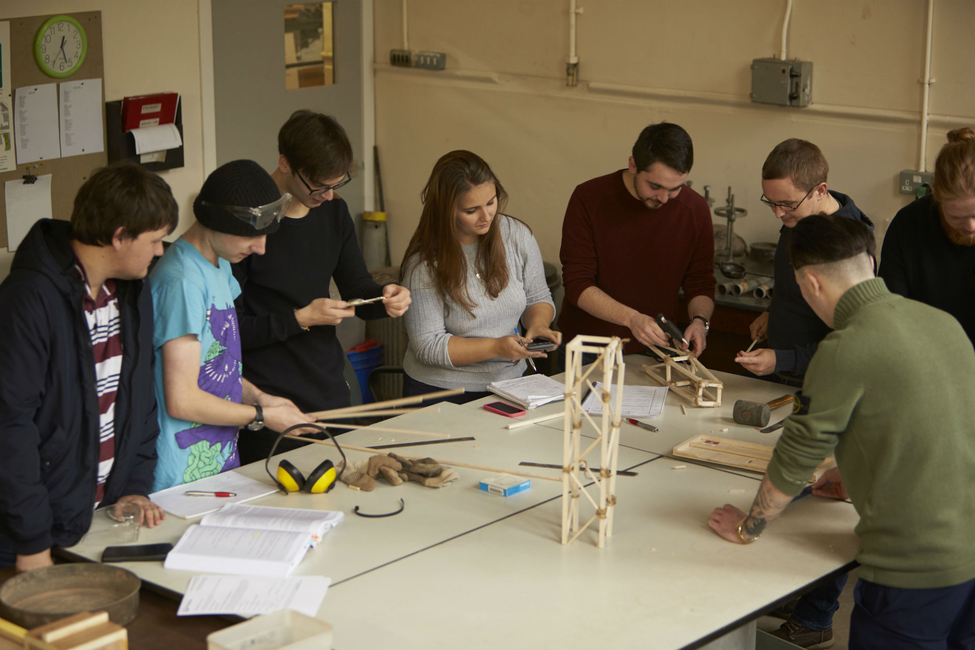 Students making a bridge using wood in Abertay's engineering laboratories.