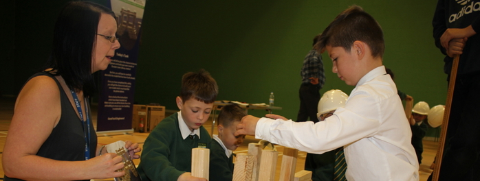 teacher and children working on engineering project