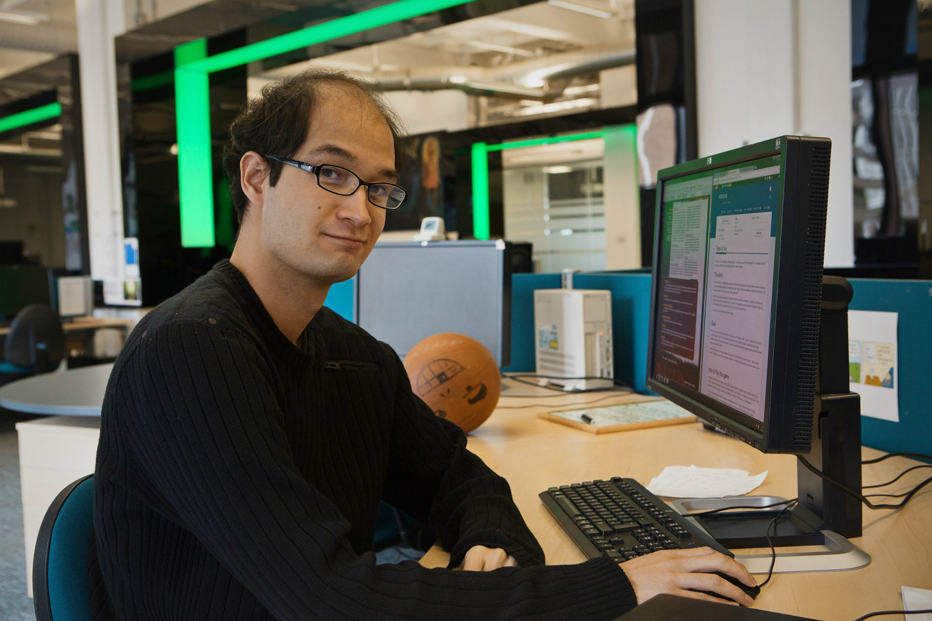 Male sitting in front of a Desktop computer