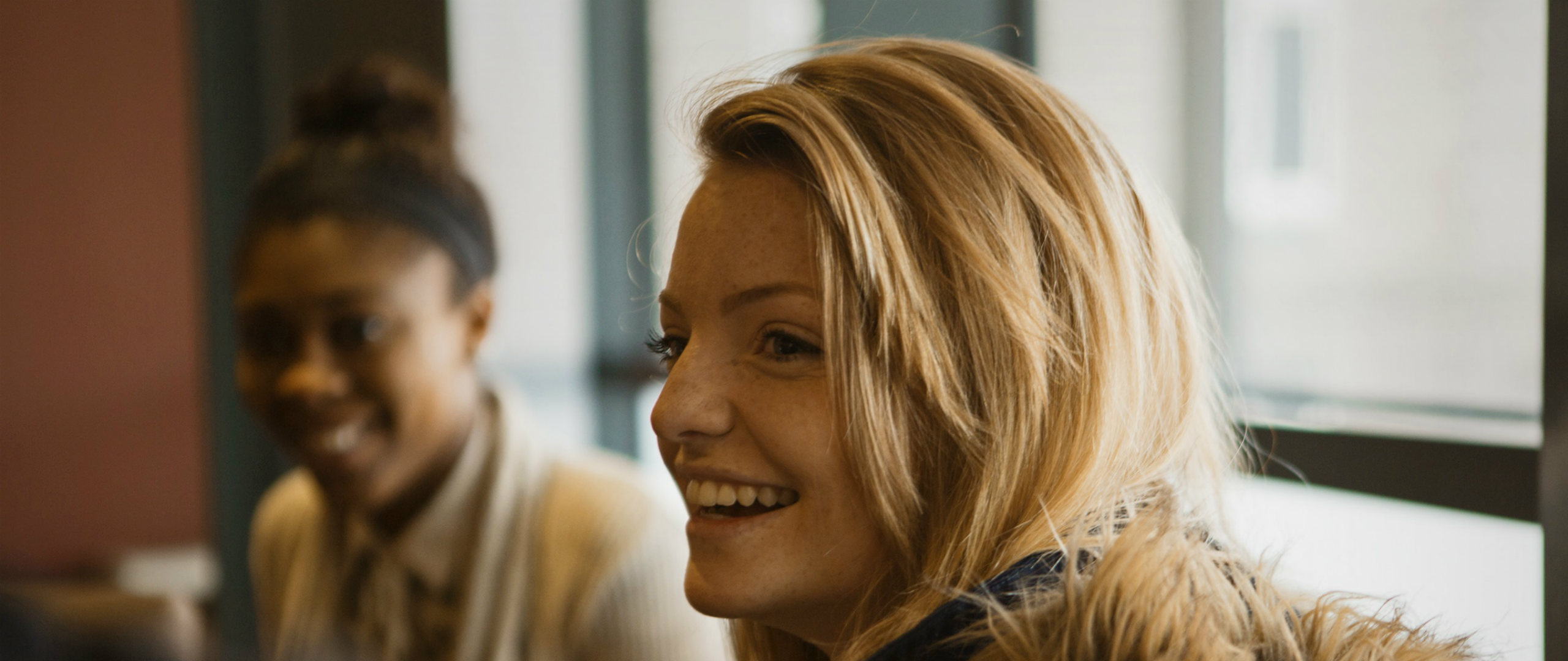 Close up of 2 smiling females