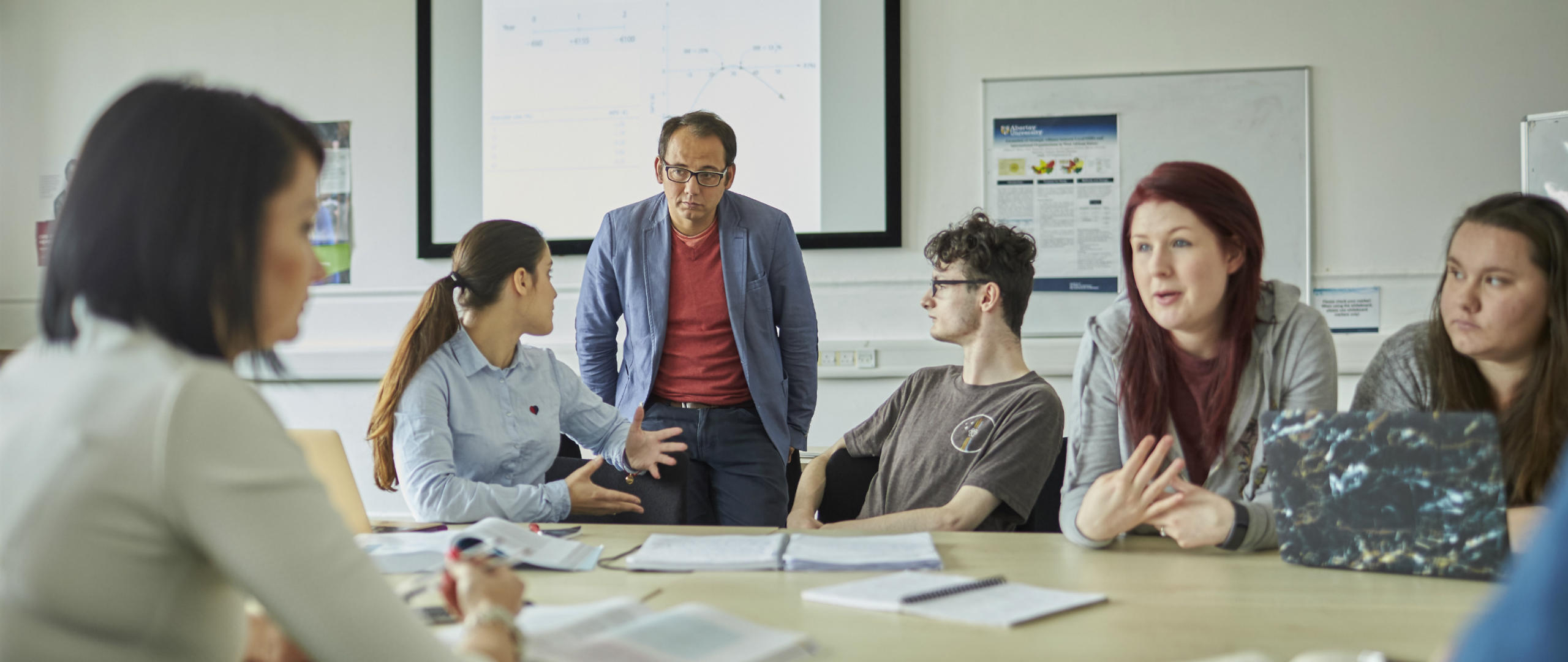 Group of people in a classroom chatting