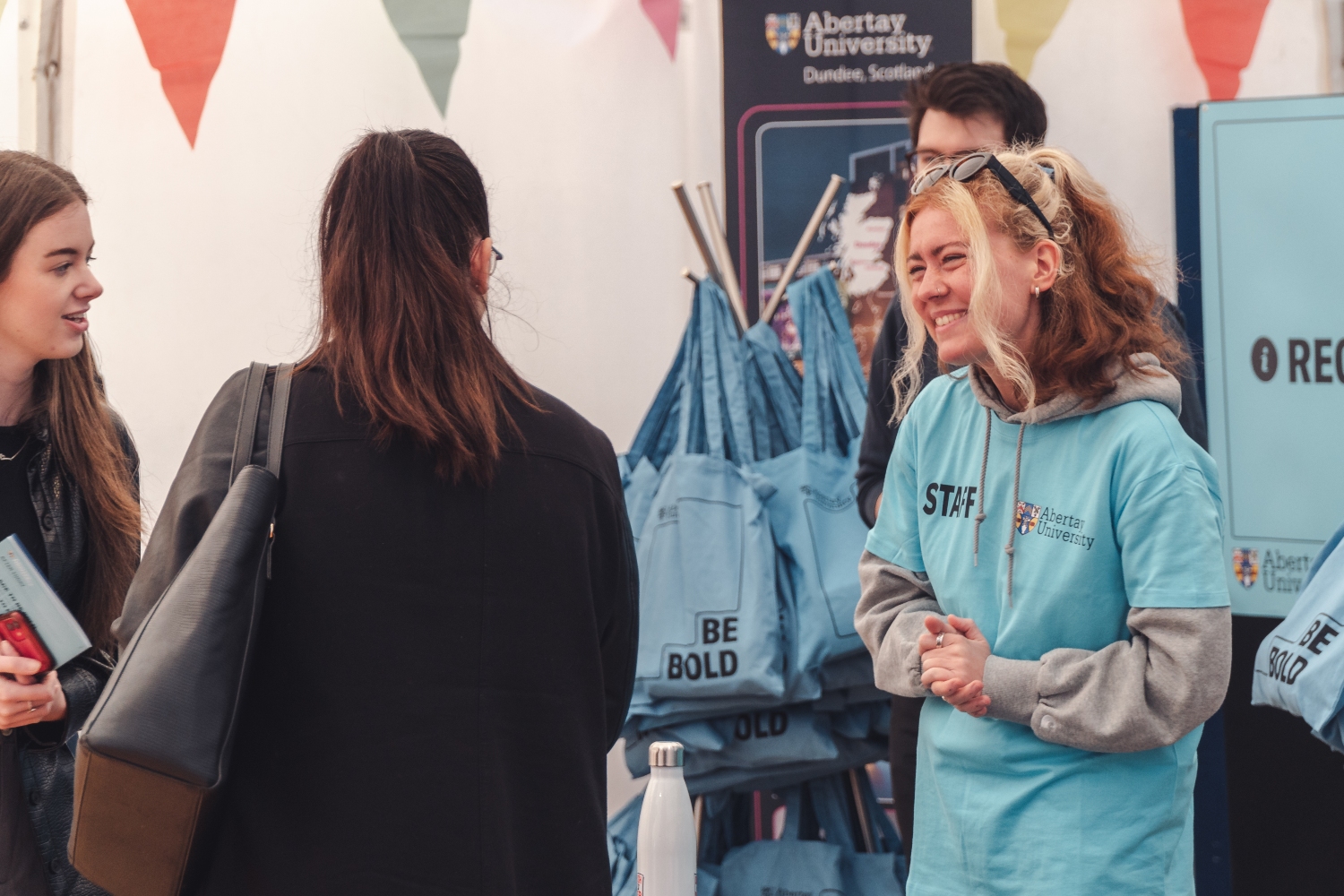 Female staff member welcoming a student and parent to Offer Holder Day