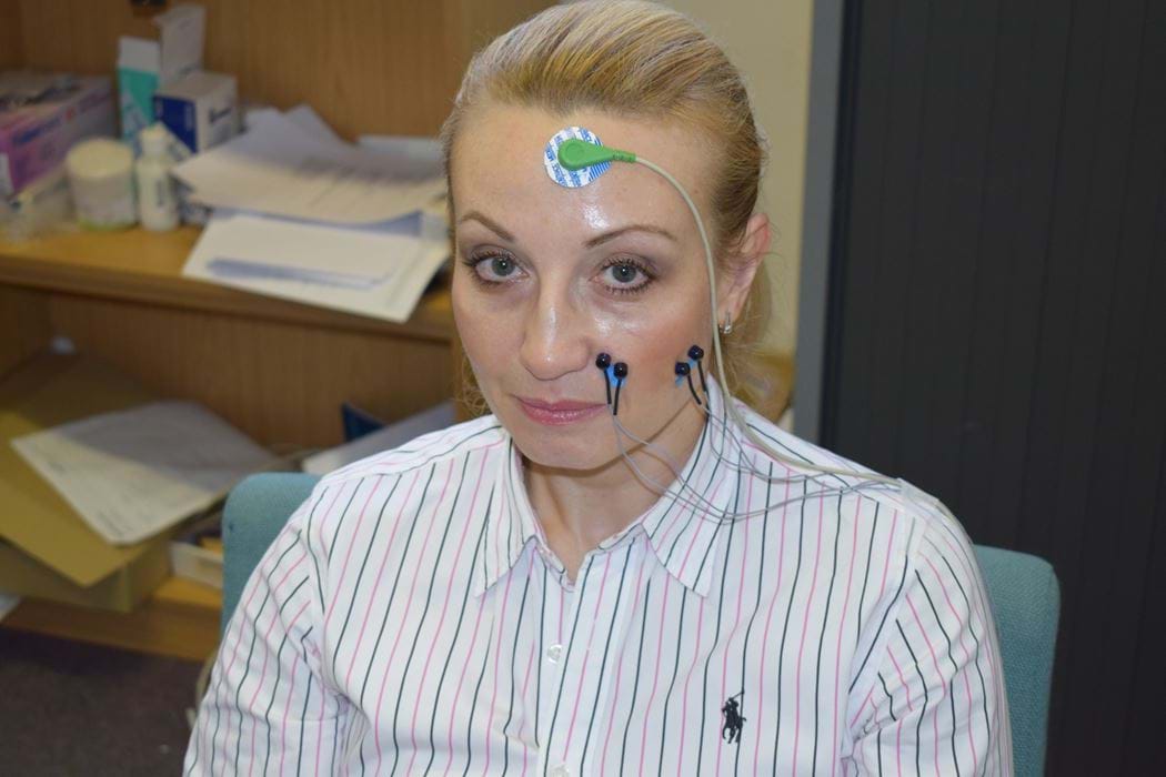 Female wearing electromyography equipment on face 
