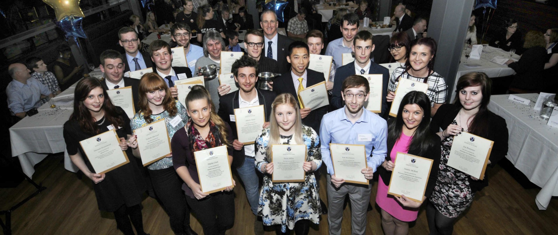 Group of people holding certificates