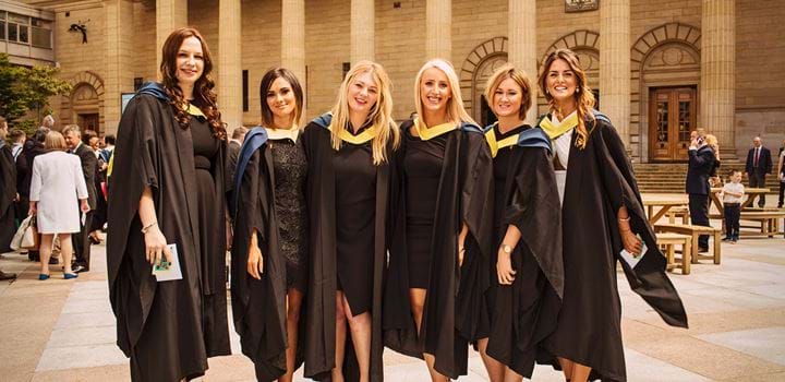 Group of female students wearing graduation gowns