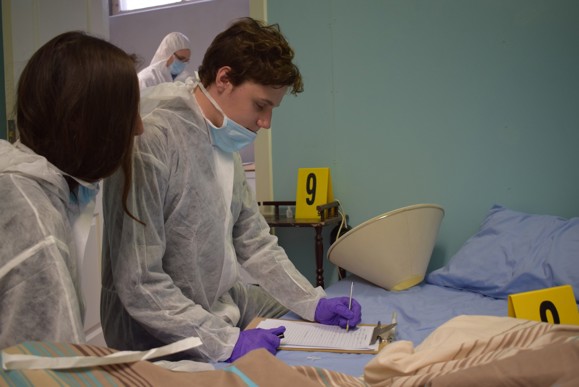 Student investigating a crime scene