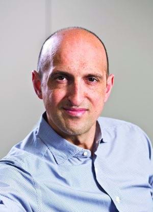 A photo of Matthew Syed in a blue shirt