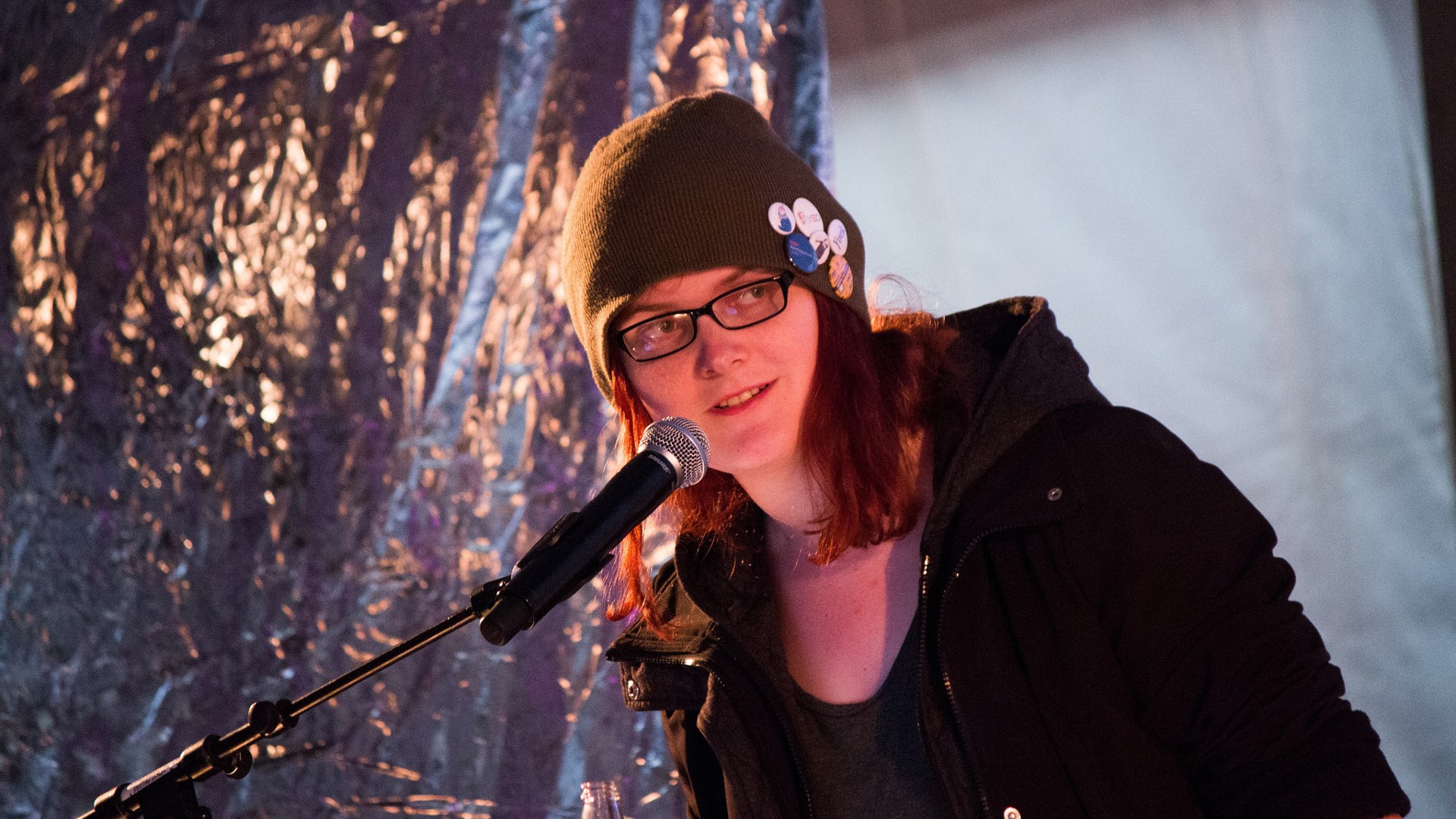 A photo of Natalie Clayton in front of a microphone