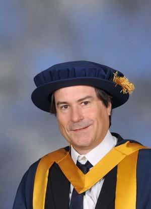 A photo of David Braben in graduation outfit