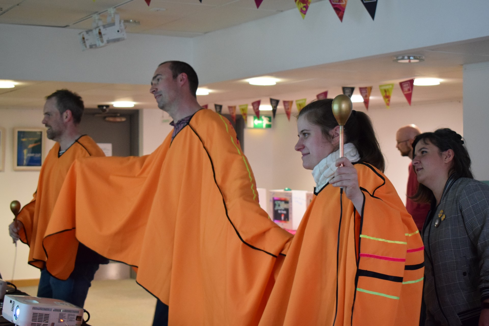 Academics wearing a three heading poncho which is used to control a special game