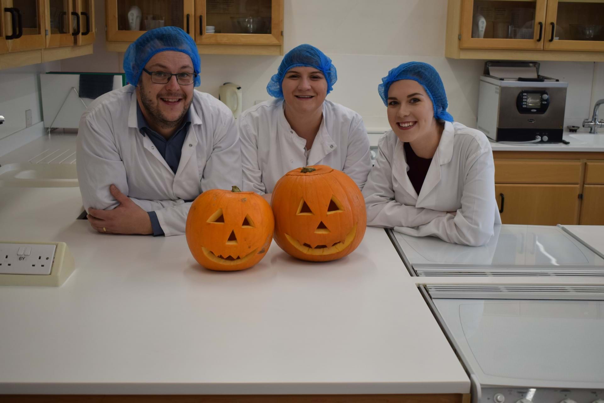 Dr Jon Wilkin and students Megan Burns and Aileen McColm with carved pumpkins
