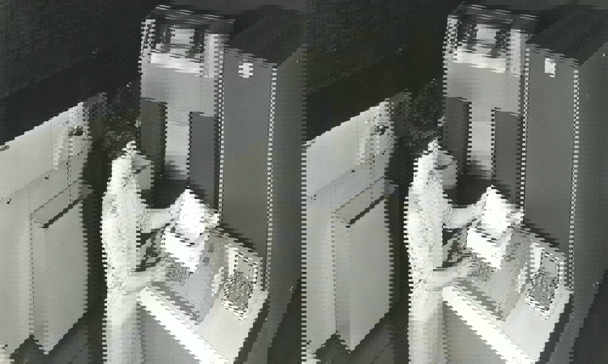 Female staff member at Dundee Institute of Art and Technology (Abertay University) looking at data being printed from a computer in the 1960s