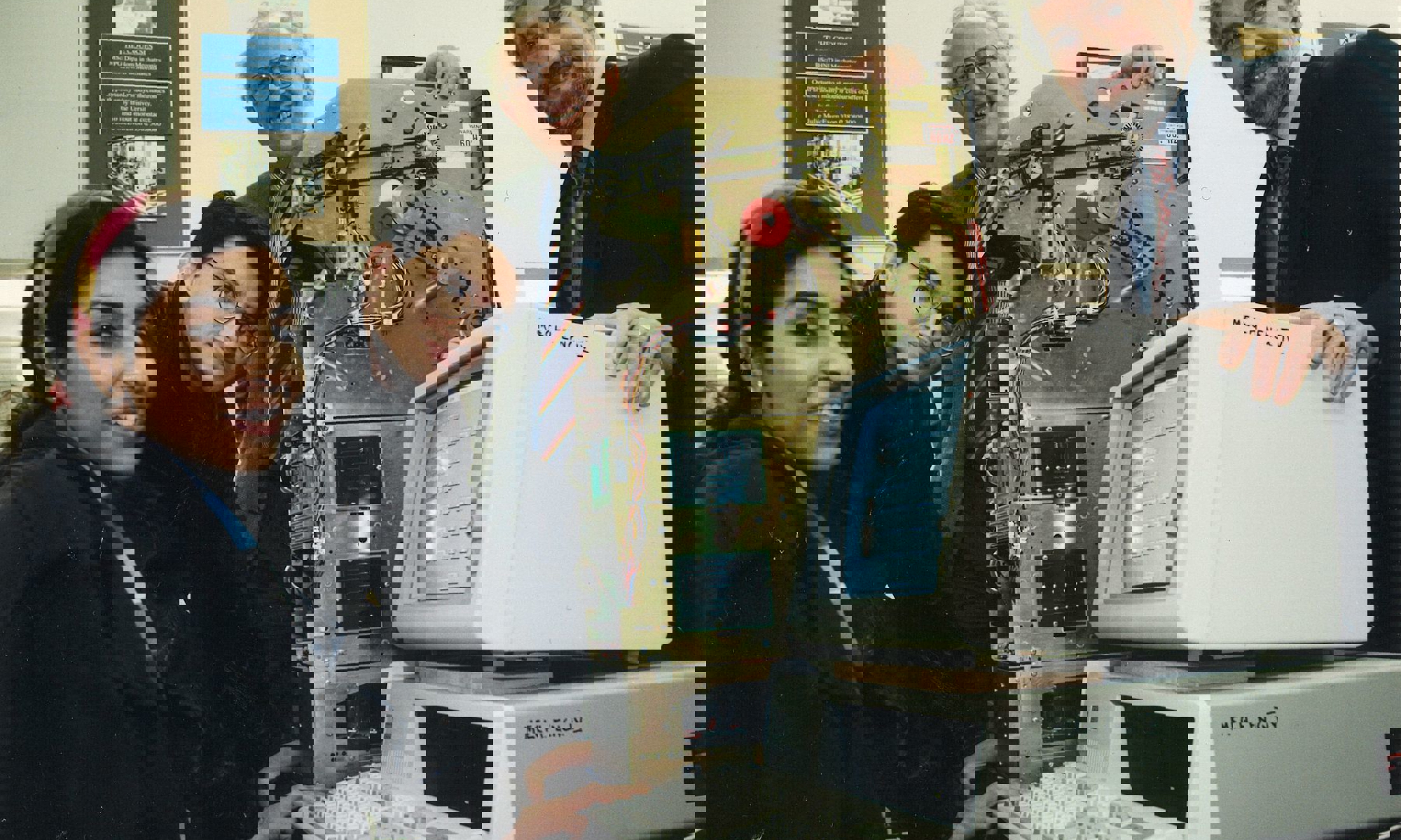 Two students, female and male, with two male lecturers in the mechanical engineering department of Dundee Institute of Technology (Abertay University) with a built ATM machine (inner parts only) and desktop computer.