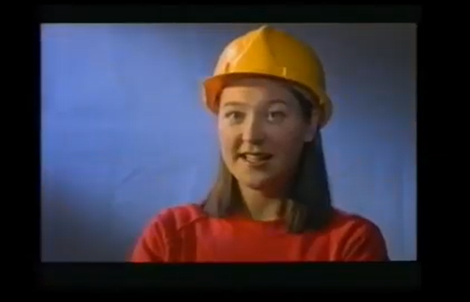 A photo of a female civil engineering student wearign a protective yellow helmet