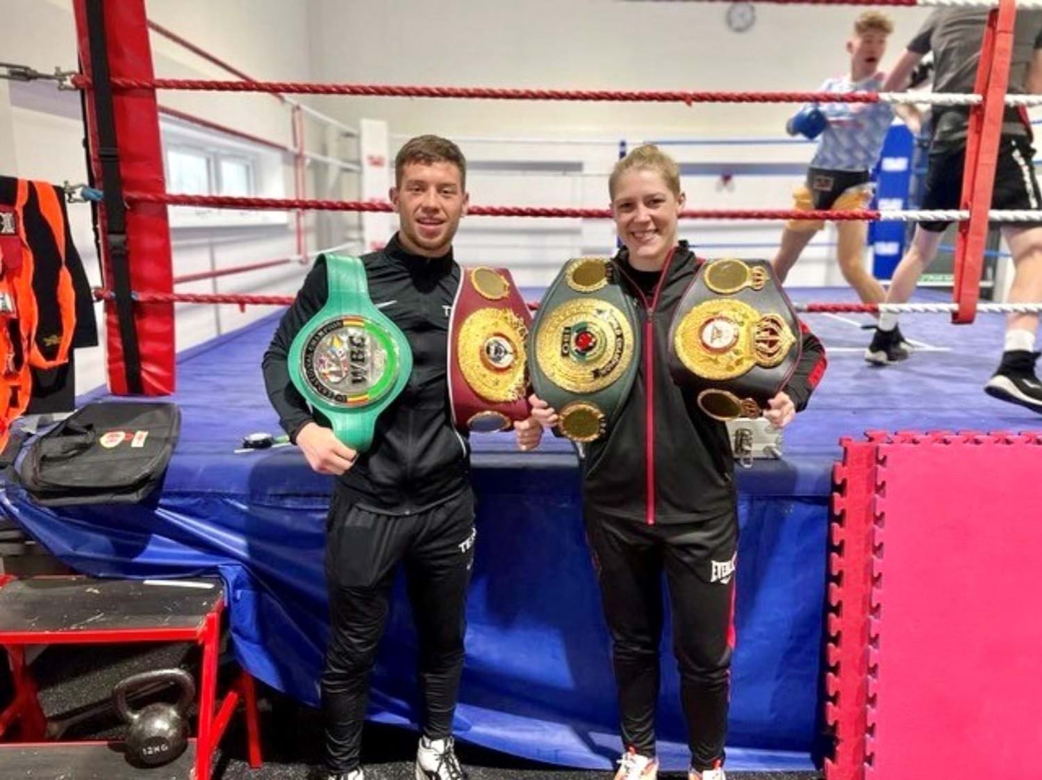 Image shows Dean Sutherland and Hannah Rankine with their title belts