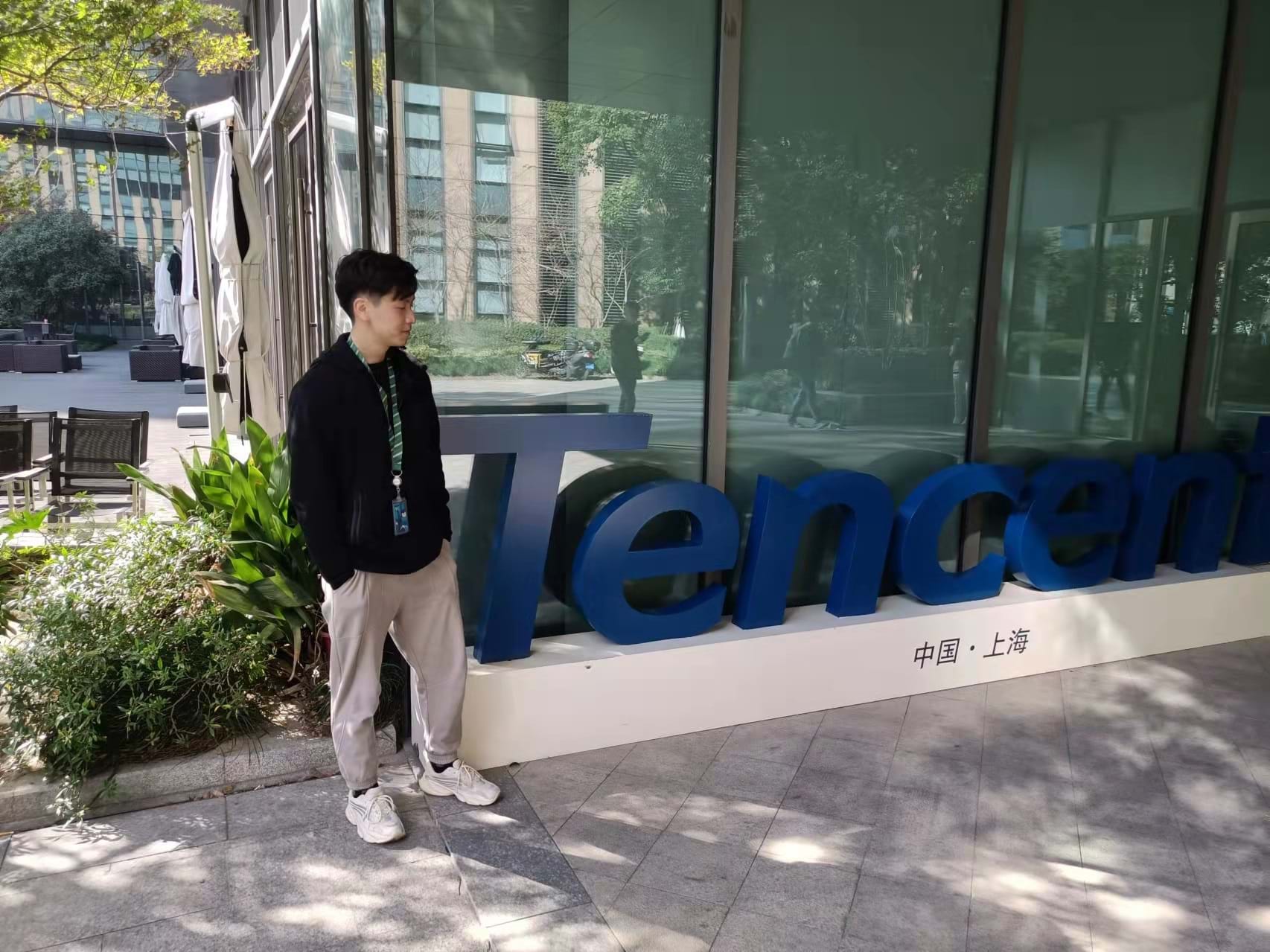 The image shows Nathan Zheng outside of his office at Chinese company Tencent