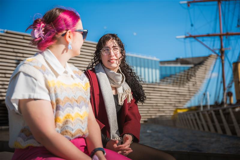 Two students sitting outside the V&A