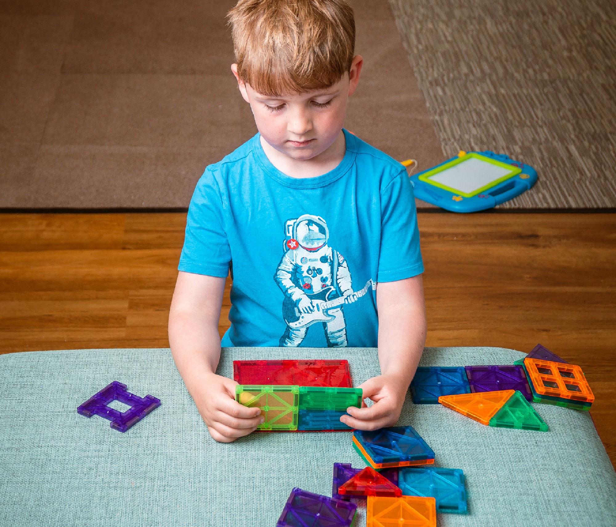 Boy playing with toys on a table